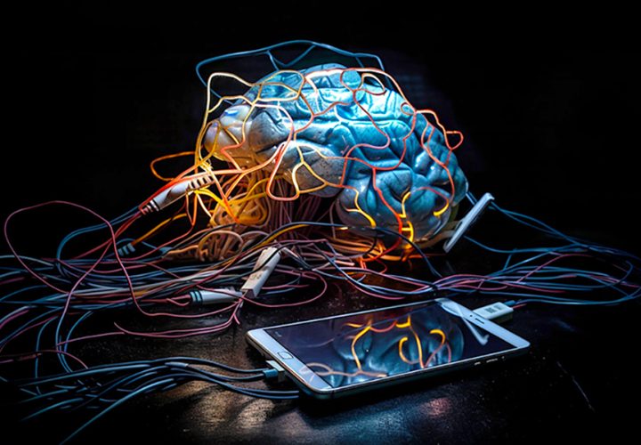 Human brain connected to a mobile phone