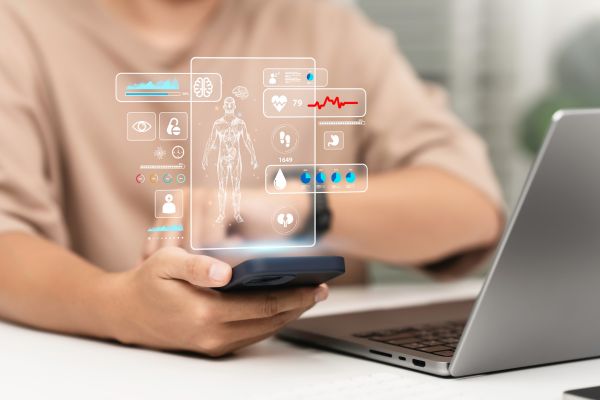 Person using a smartphone with AI health app displaying digital health metrics, representing AI health advice and modern health tracking technology
